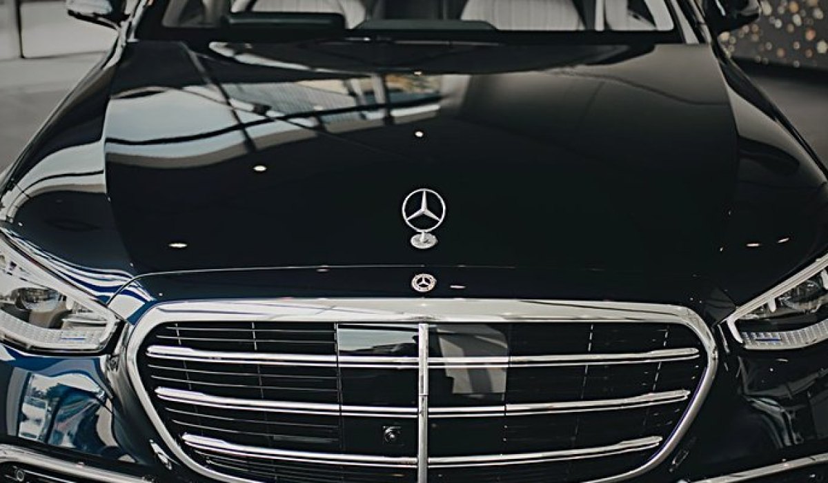 The bonnet and chrome grille of a black Mercedes-Benz S-Class saloon.